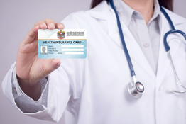 Staff holding patient insurance card