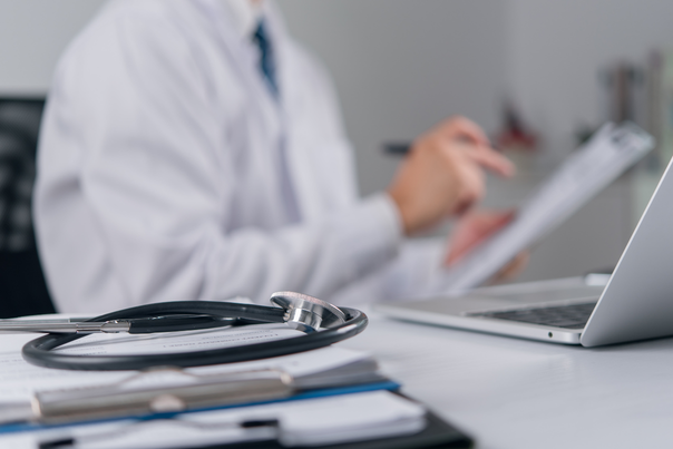Doctor reviewing the documents for insurance claims