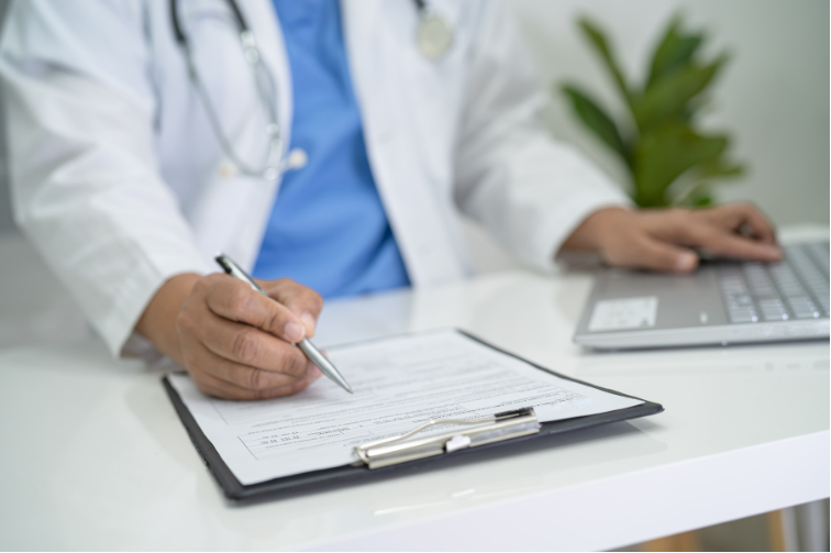 A clinician inputing data