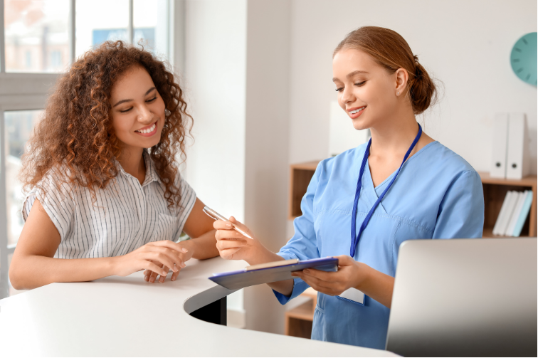 Receptionist looking at reports with admin of clinic