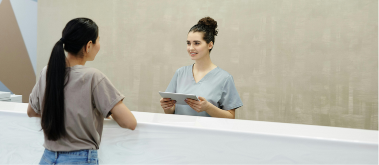 Receptionist standing with patient