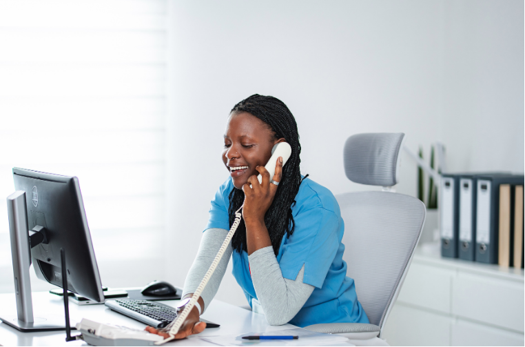 Receptionist on the phone confirming appointments that were booked online